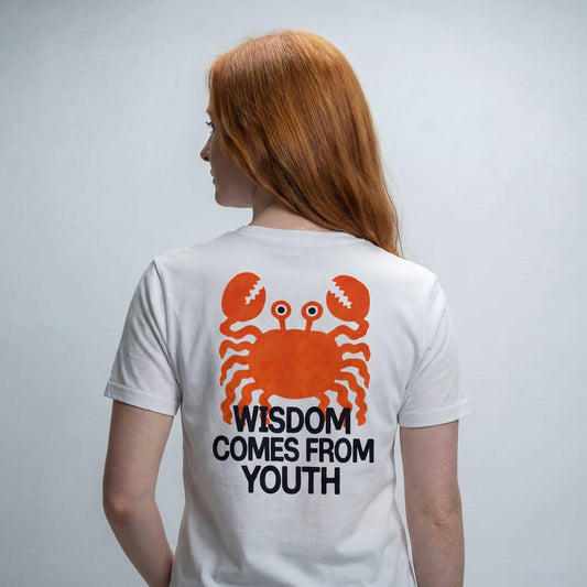 Wisdom comes from Youth white organic cotton t-shirt by Woke FC — back view with crab design