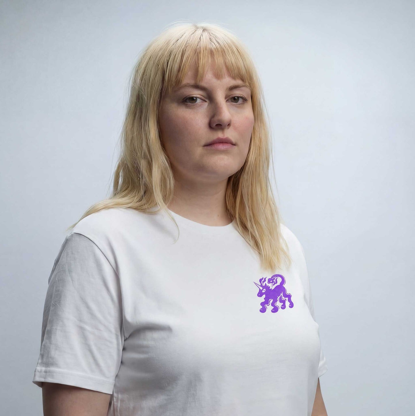 Fierce Freedom white organic cotton t-shirt by Woke FC — front view with unicorn and snake graphic