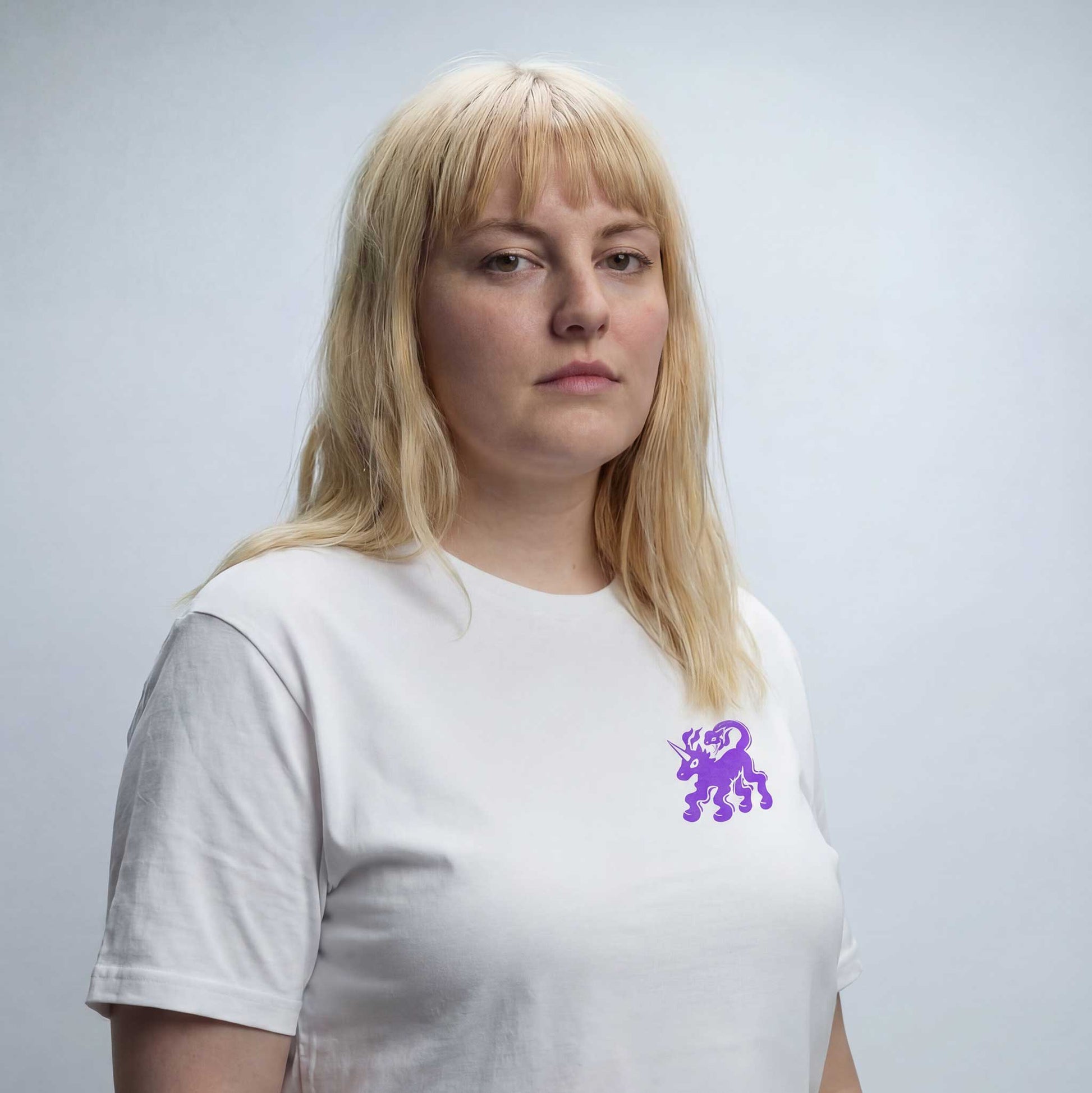 Fierce Freedom white organic cotton t-shirt by Woke FC — front view with unicorn and snake graphic