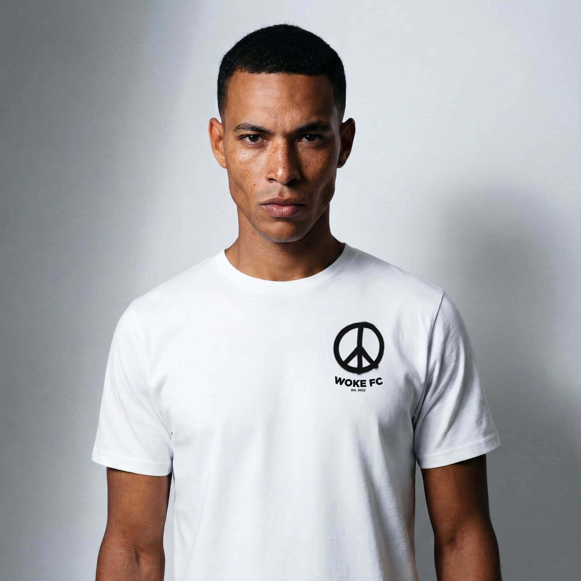 Woke Peace (Spray it) white organic cotton t-shirt — lifestyle front view by Woke FC