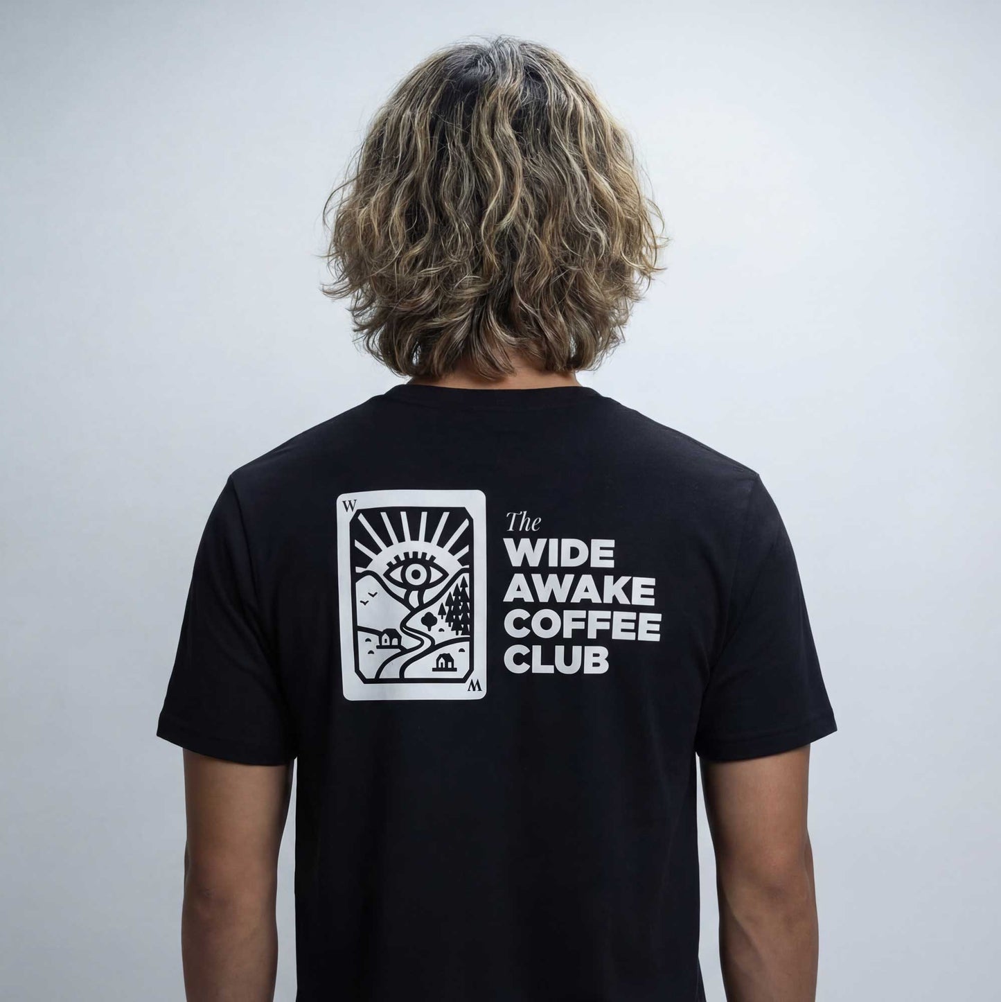 Wide Awake Coffee Club organic cotton t-shirt worn — lifestyle back view showing rear print by Woke FC