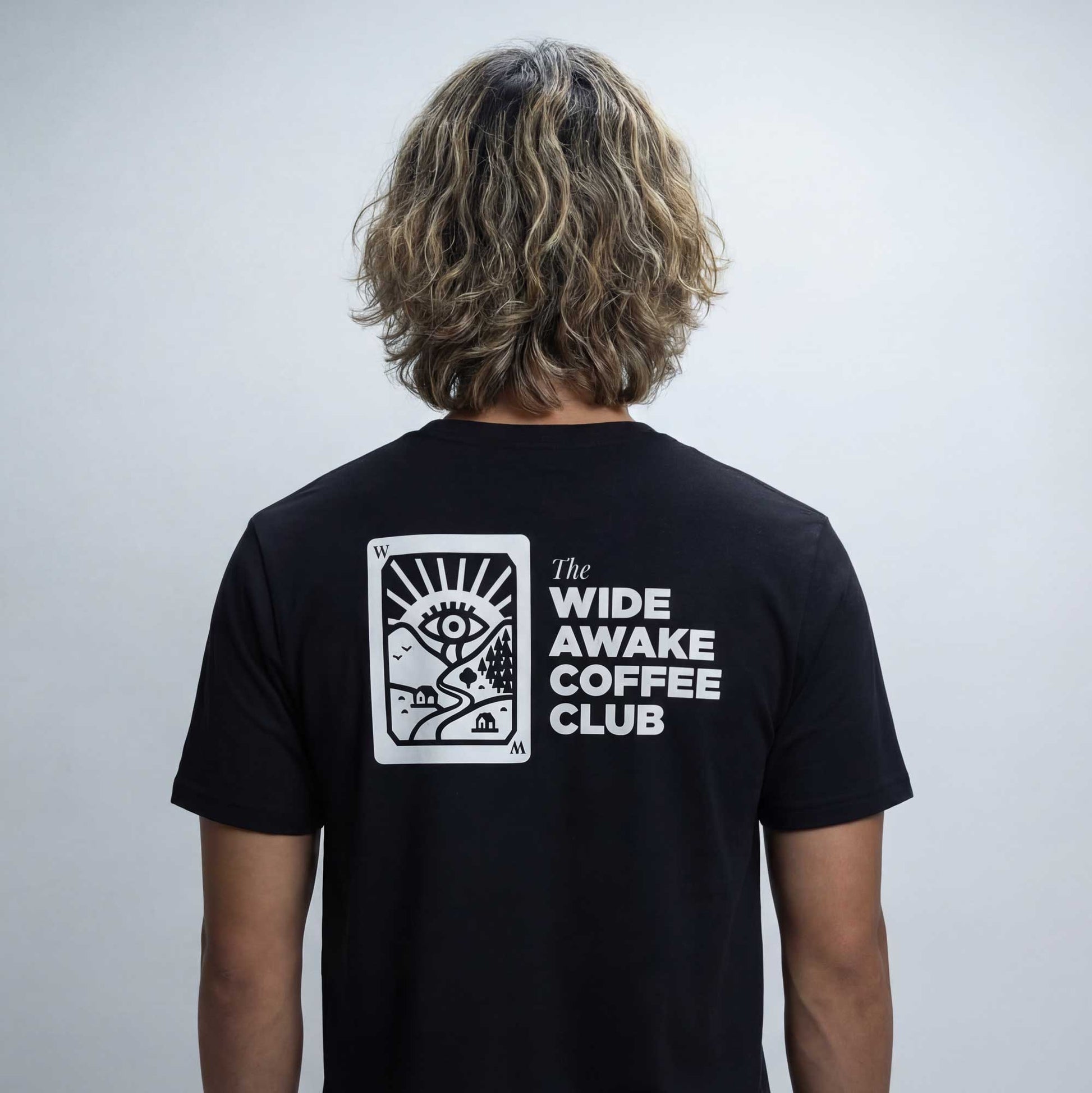 Wide Awake Coffee Club organic cotton t-shirt worn — lifestyle back view showing rear print by Woke FC