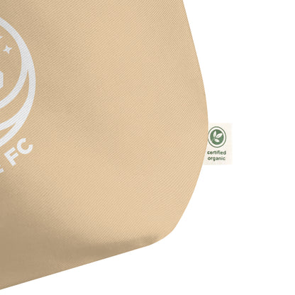 Close-up of WOKE FC unicorn crest printed on organic tote bag